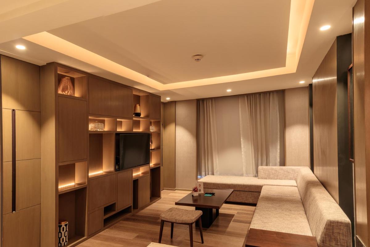 a living room with a couch and a table at Courtyard by Marriott Amritsar in Amritsar