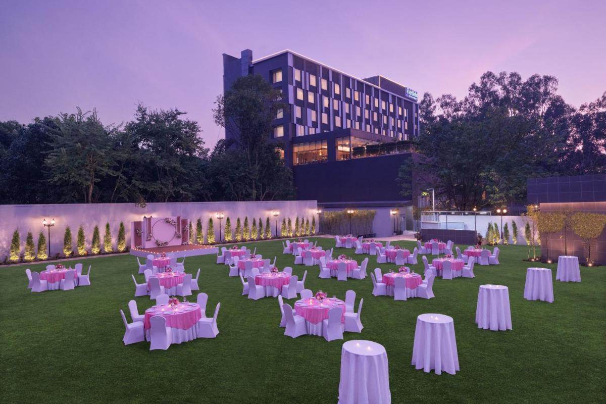 a group of tables and chairs in a field at Fairfield by Marriott Dehradun in Dehradun +55 photos