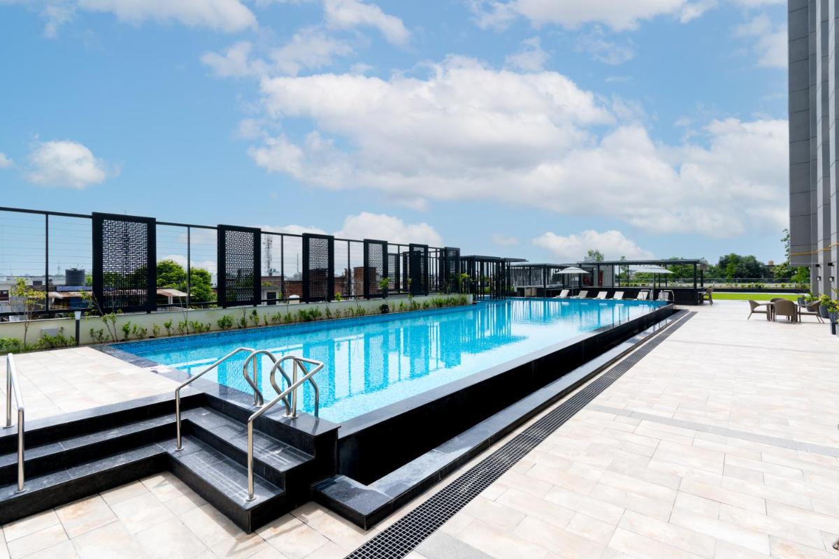 a swimming pool on the roof of a building at Holiday Inn Lucknow Airport by IHG in Lucknow