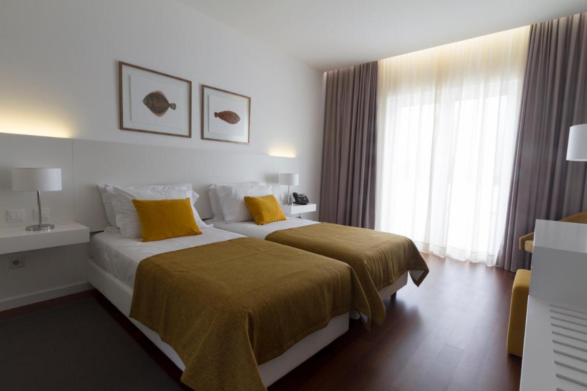 Uma cama ou camas num quarto em Hotel Vila D'Óbidos
