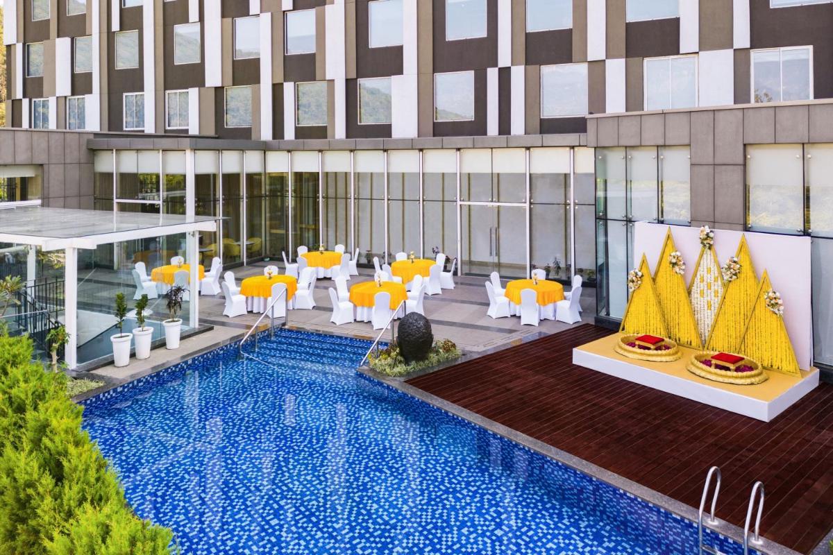 a rendering of a hotel lobby with a swimming pool at Fairfield by Marriott Dehradun in Dehradun