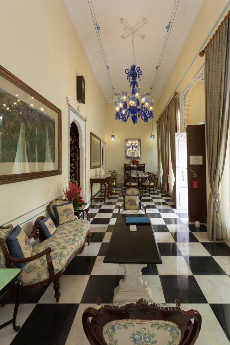 a living room with a black and white checkered floor at Shiv Niwas Palace by HRH Group of Hotels in Udaipur