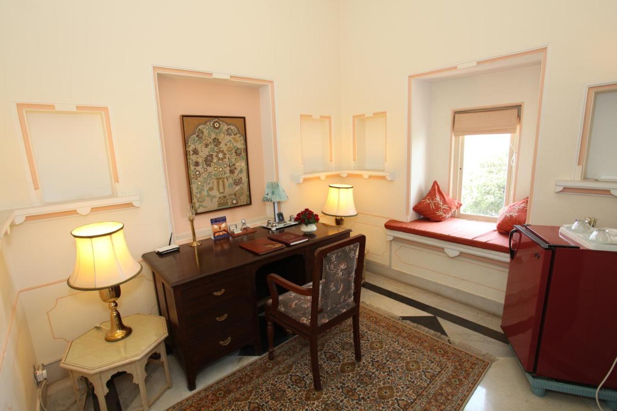 a home office with a desk and a window at Shiv Niwas Palace by HRH Group of Hotels in Udaipur