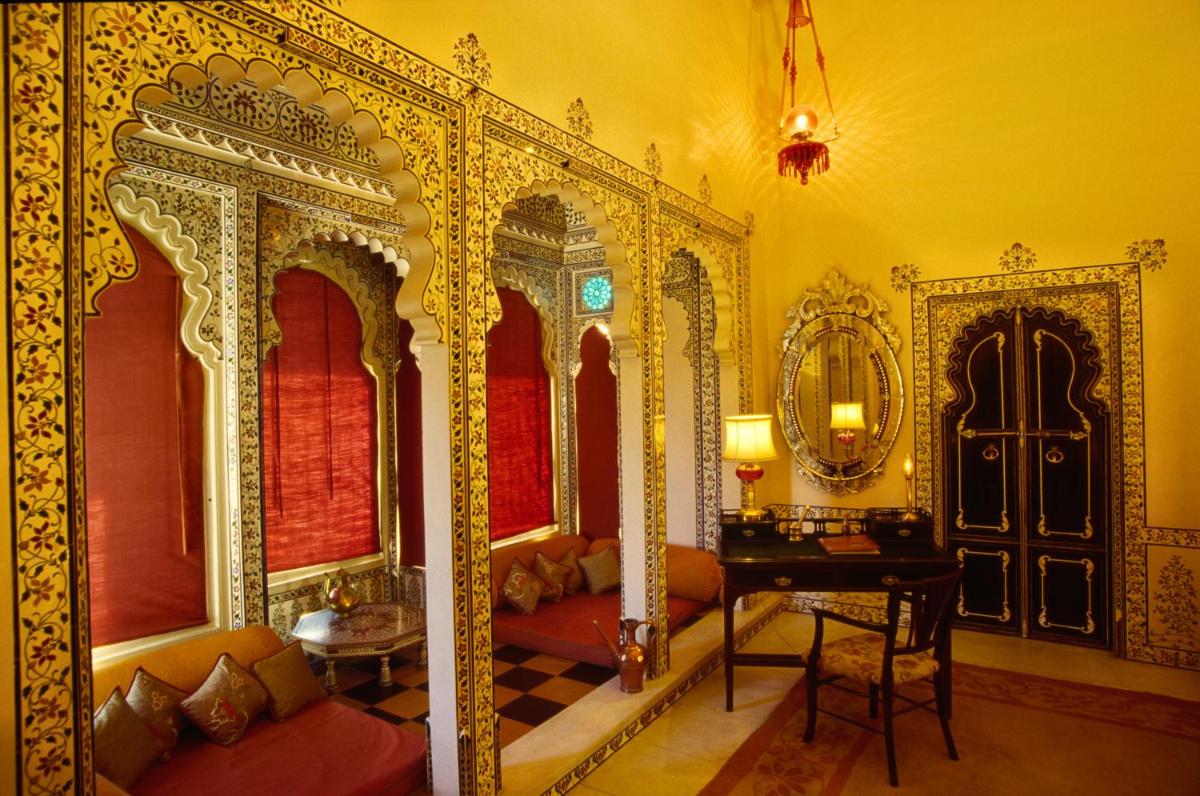 an ornate bedroom with a bed and a mirror at Shiv Niwas Palace by HRH Group of Hotels in Udaipur