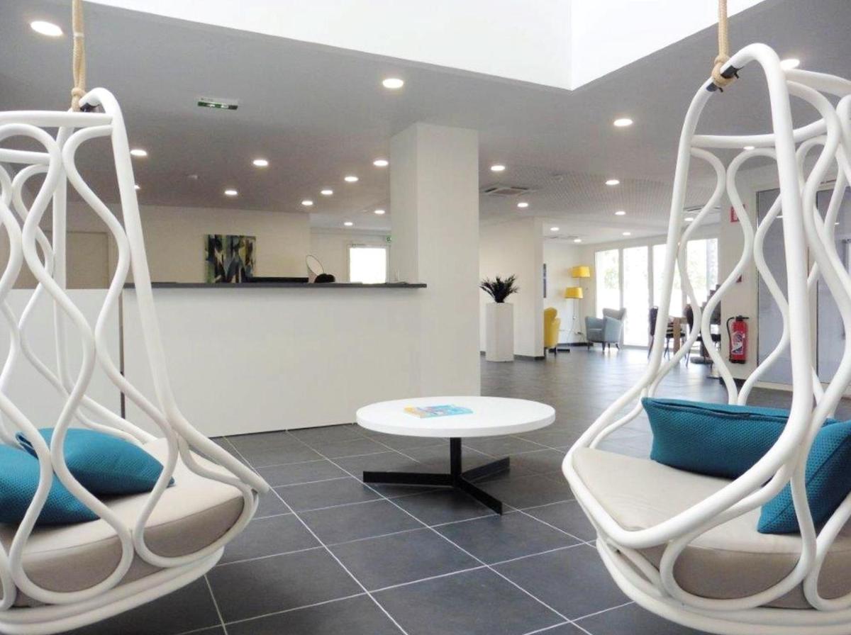Coin salon dans l'établissement Appart'Hotel Odalys Nakâra