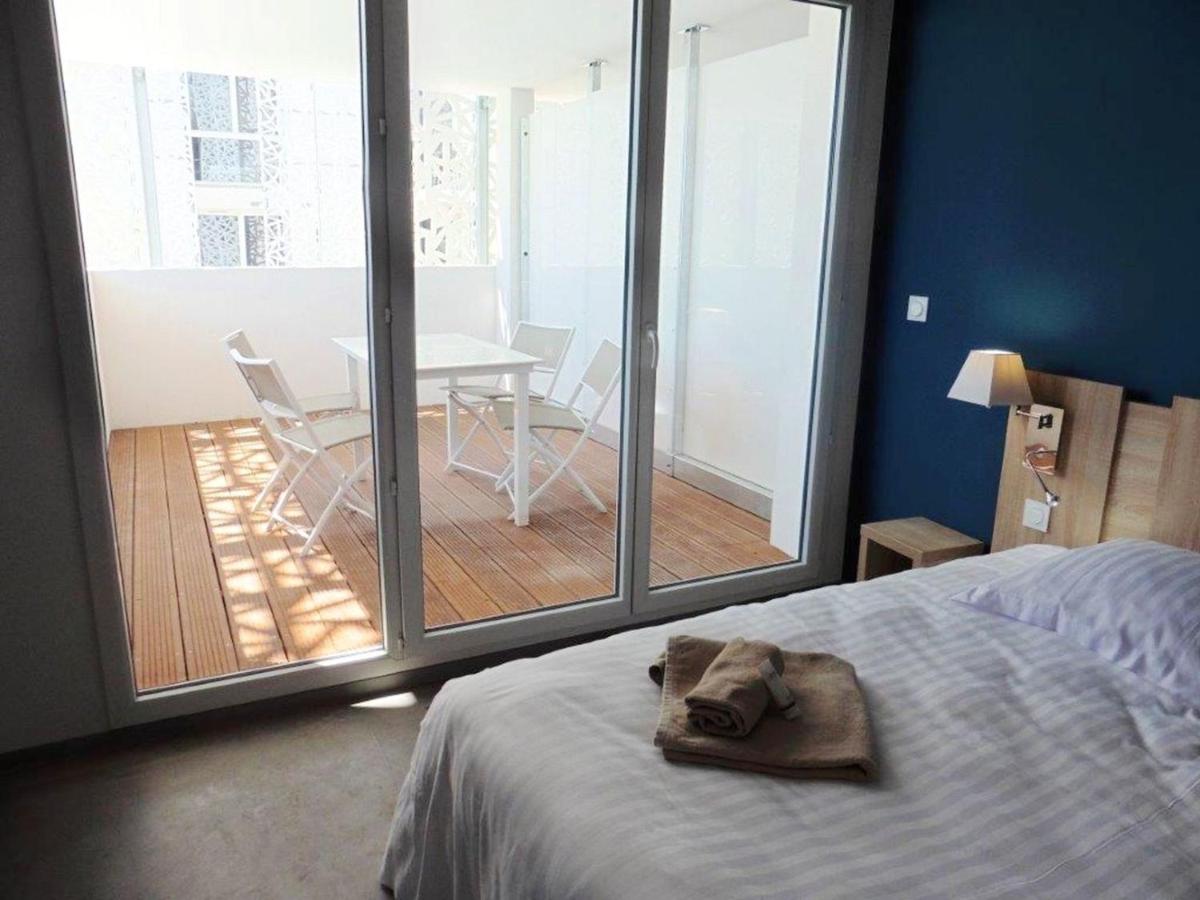 Un ou plusieurs lits dans un hébergement de l'établissement Appart'Hotel Odalys Nakâra