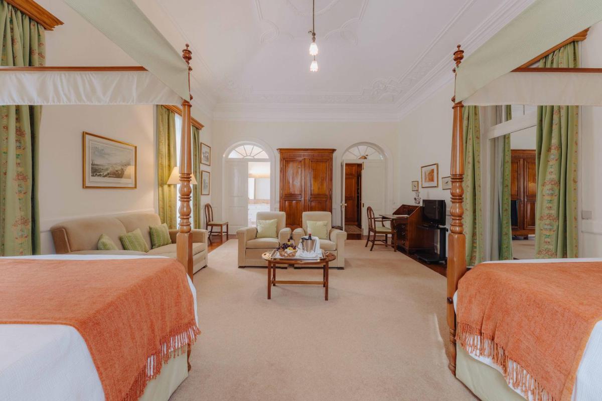 um quarto com duas camas e uma sala de estar em Quinta da Bela Vista no Funchal