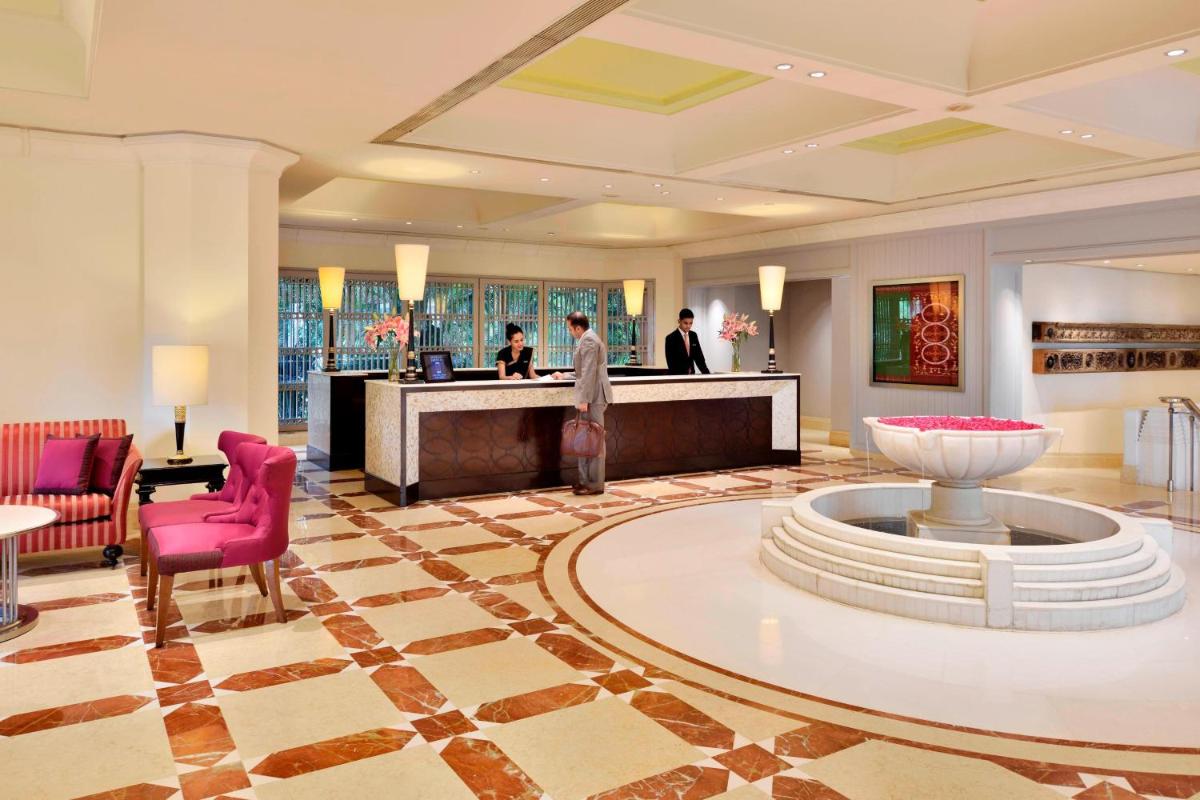 a lobby of a hotel with a reception desk at Hyderabad Marriott Hotel & Convention Centre in Hyderabad