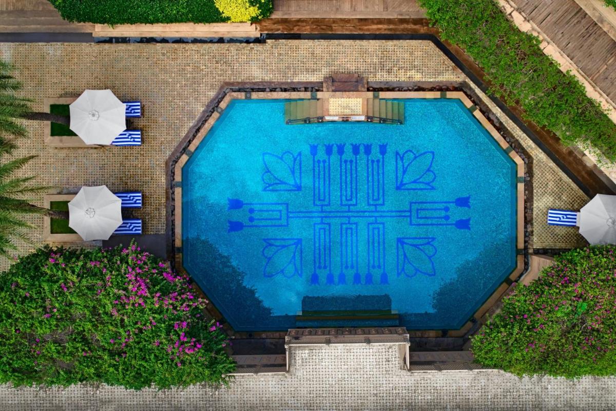 an overhead view of a swimming pool with umbrellas and flowers at Hyderabad Marriott Hotel & Convention Centre in Hyderabad