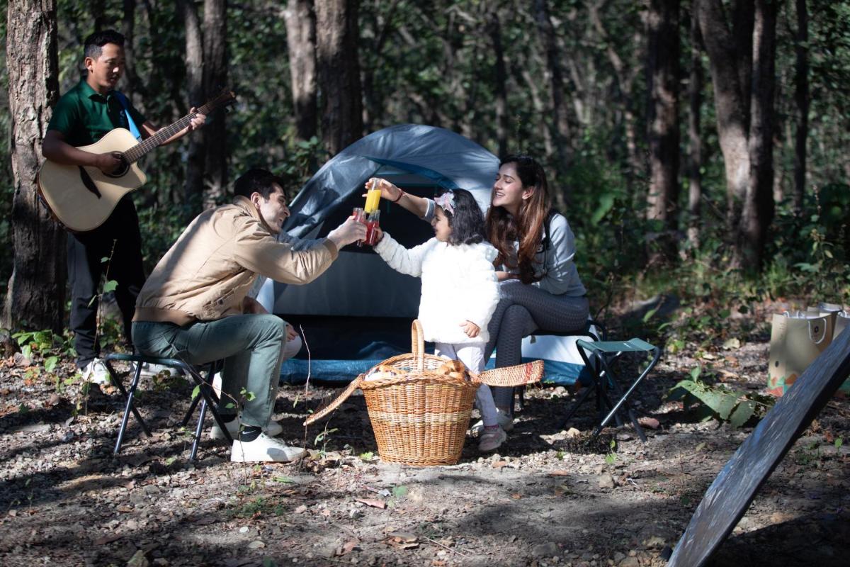 a group of people sitting in front of a tent at Hyatt Regency Dehradun Resort and Spa in Dehradun