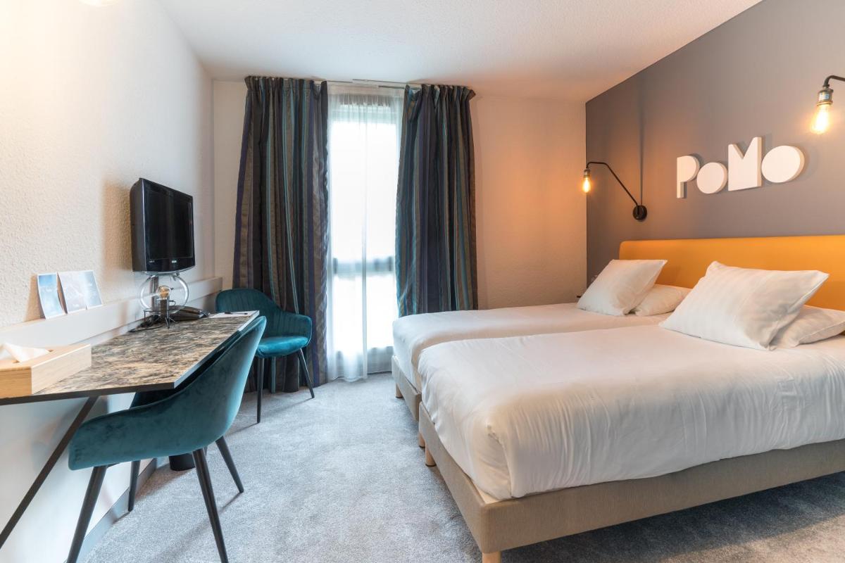 Un ou plusieurs lits dans un hébergement de l'établissement PoMo Hôtel & Restaurant