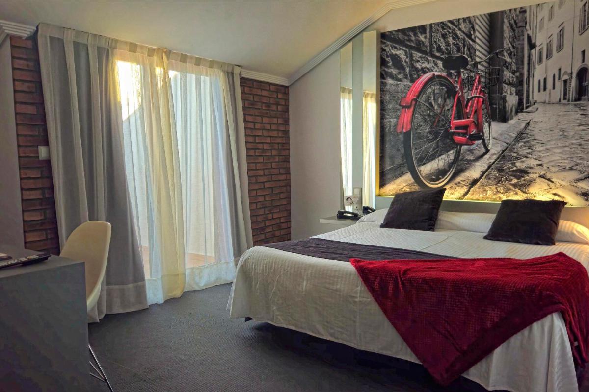 Cama o camas de una habitación en Hotel Spa El Muelle de Suances