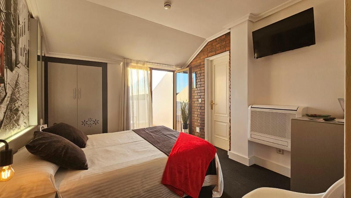 Cama o camas de una habitación en Hotel Spa El Muelle de Suances
