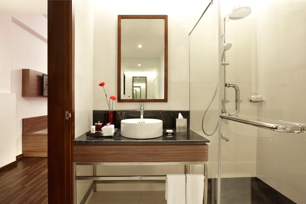 a bathroom with a sink and a mirror at Vivanta Kolkata EM Bypass in Kolkata