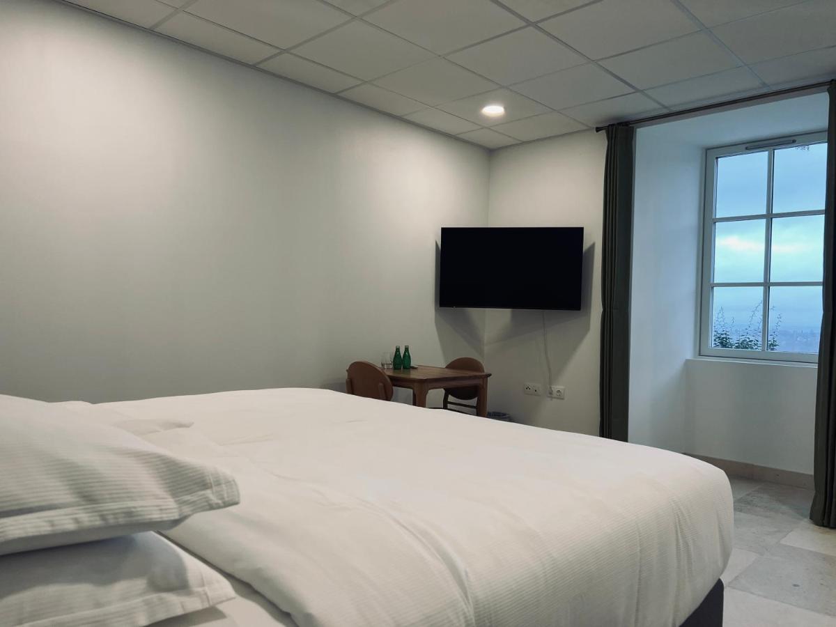 Un ou plusieurs lits dans un hébergement de l'établissement Château Lecusse - La Grande Roche - Hôtel, Spa, Boutique & Restaurant