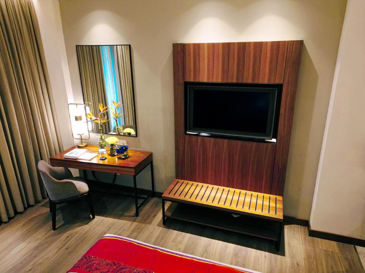 a hotel room with a desk and a television at Vivanta Kolkata EM Bypass in Kolkata