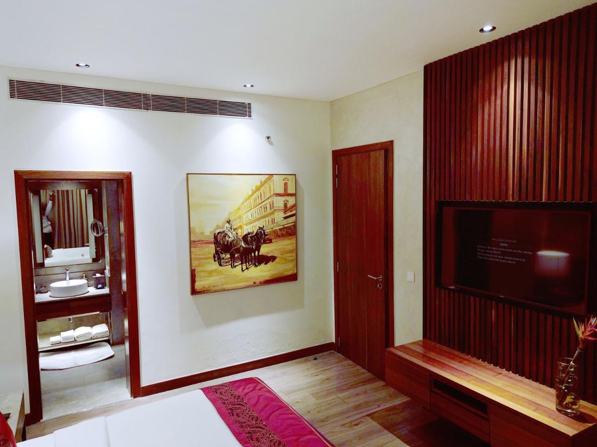 a living room with a television and a painting on the wall at Vivanta Kolkata EM Bypass in Kolkata
