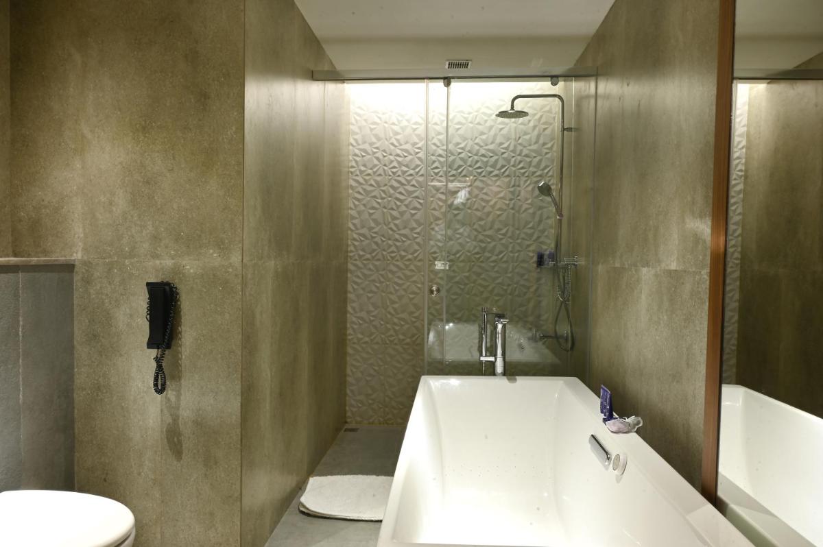 a bathroom with a sink and a toilet and a shower at Vivanta Kolkata EM Bypass in Kolkata