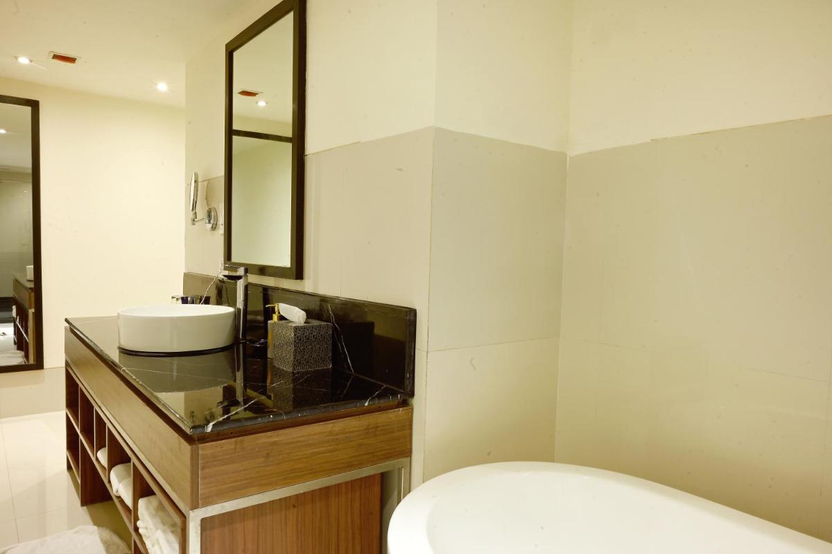 a bathroom with a sink and a mirror at Vivanta Kolkata EM Bypass in Kolkata