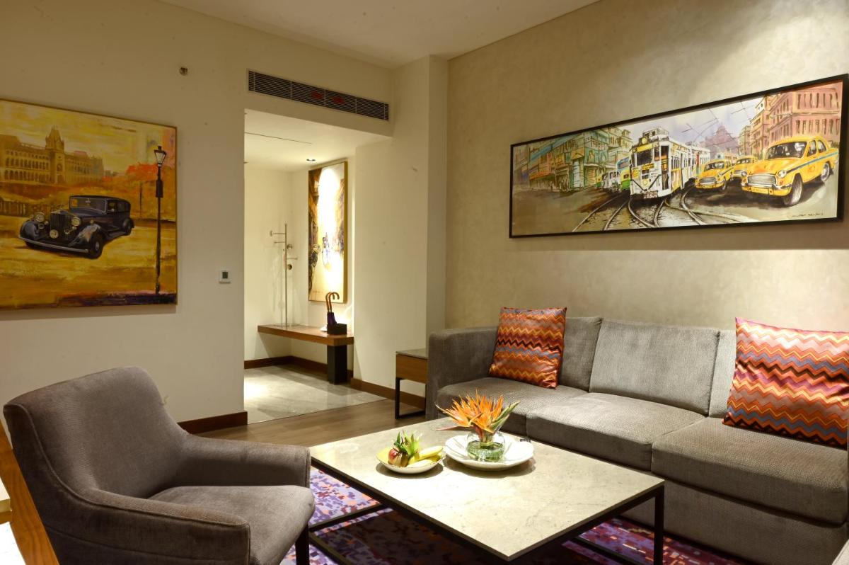 a living room with a couch and a table at Vivanta Kolkata EM Bypass in Kolkata