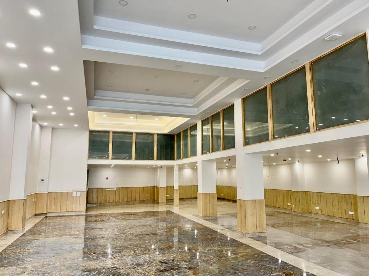 a large building with a large room with windows at The Prominence Mussoorie Road Dehradun in Dehradun