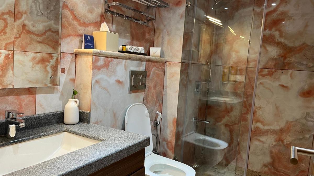 a bathroom with a shower and a sink and a toilet at The Prominence Mussoorie Road Dehradun in Dehradun