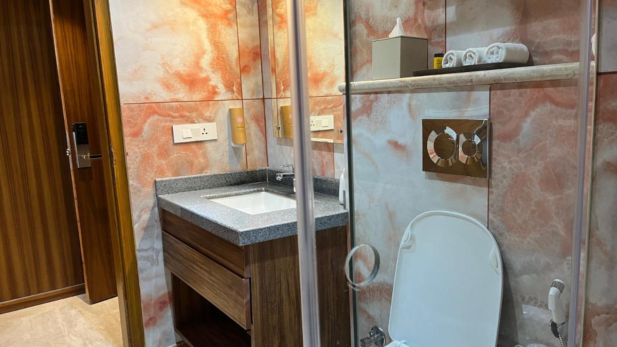 a small bathroom with a sink and a toilet at The Prominence Mussoorie Road Dehradun in Dehradun