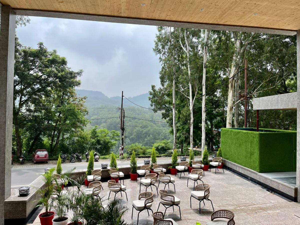 a patio with chairs and tables with a view at The Prominence Mussoorie Road Dehradun in Dehradun