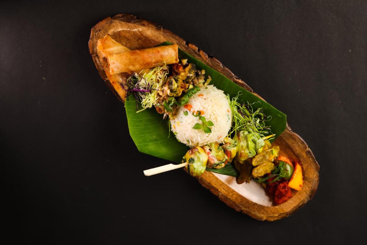 a piece of bread with food on a banana leaf at The Prominence Mussoorie Road Dehradun in Dehradun
