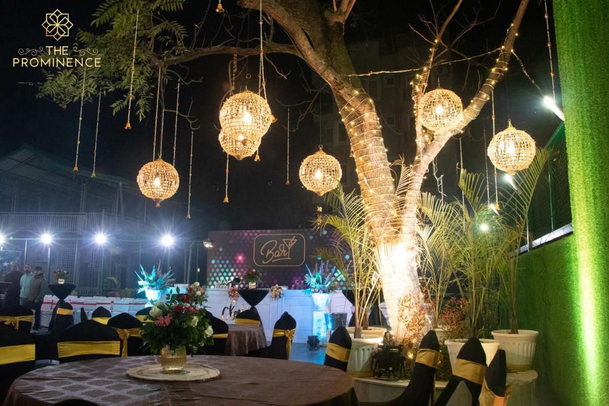 a room with a table with lights and a tree at The Prominence Mussoorie Road Dehradun in Dehradun