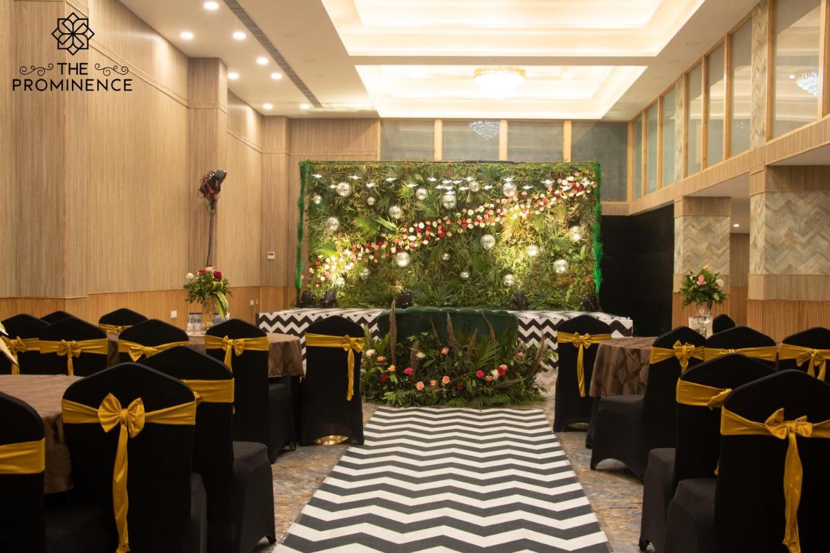 a banquet hall with tables and chairs and a large painting at The Prominence Mussoorie Road Dehradun in Dehradun