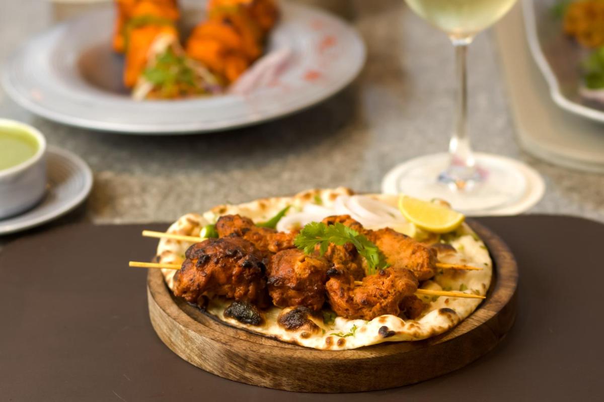 a plate of food on a table with a plate of food at The Prominence Mussoorie Road Dehradun in Dehradun