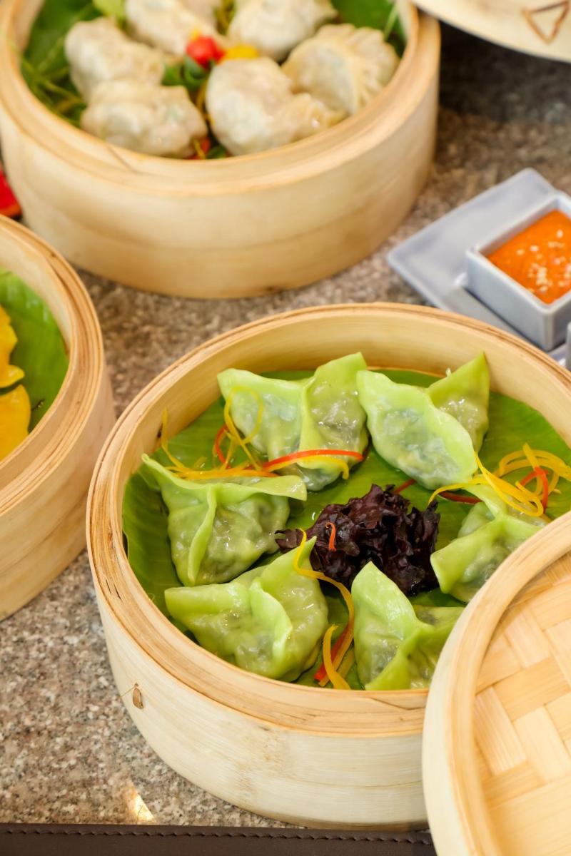 a wooden bowl filled with lettuce and other vegetables at The Prominence Mussoorie Road Dehradun in Dehradun