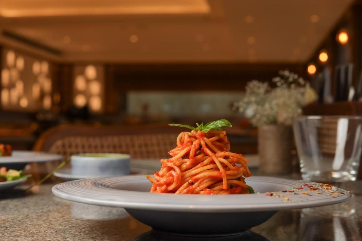 a plate of pasta sitting on a table at The Prominence Mussoorie Road Dehradun in Dehradun