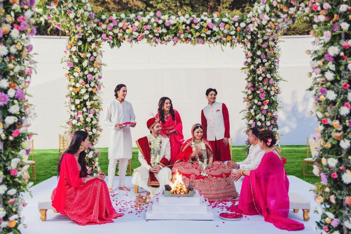 a group of people sitting under an arch with flowers at Fairfield by Marriott Dehradun in Dehradun