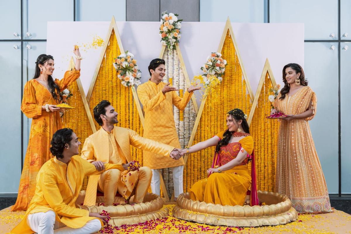 a group of people shaking hands in front of a cake at Fairfield by Marriott Dehradun in Dehradun