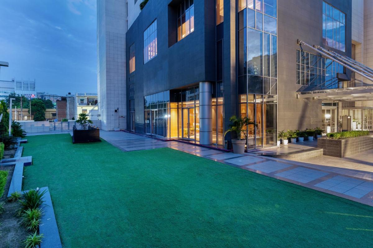 a green lawn in front of a building at Hyatt Regency Lucknow Gomti Nagar in Lucknow