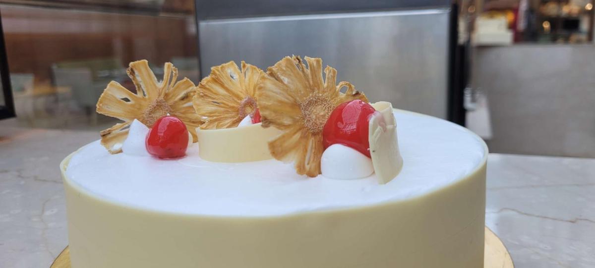 a white cake with birds on top of it at Radisson Blu Hotel, Greater Noida in Greater Noida