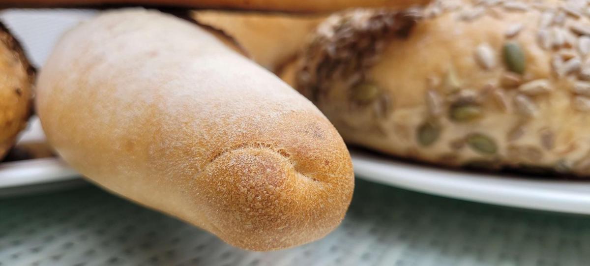 a close up of a piece of bread next to a plate of food at Radisson Blu Hotel, Greater Noida in Greater Noida