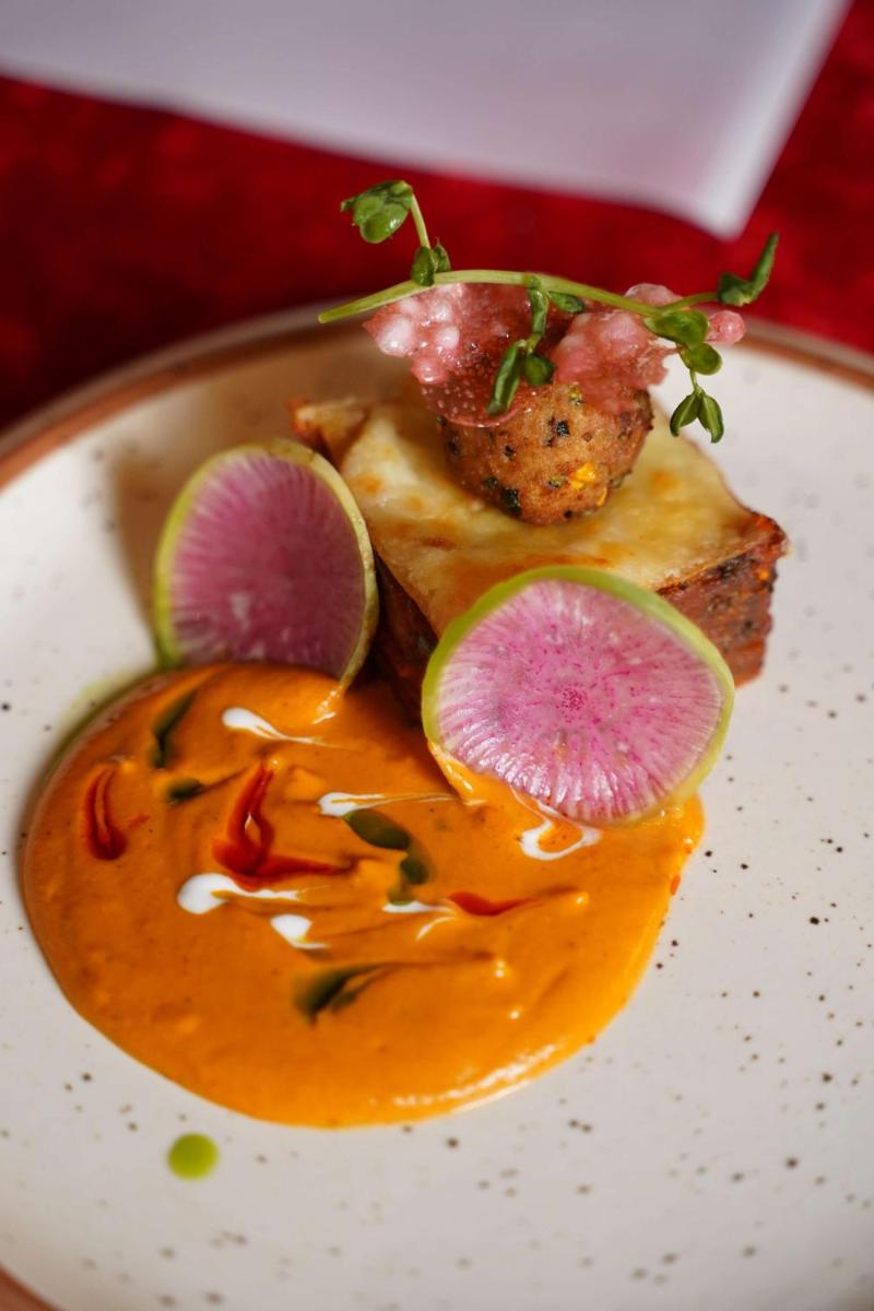 a plate of food with a piece of food with vegetables at Radisson Blu Hotel, Greater Noida in Greater Noida