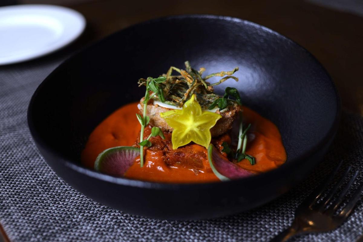 a black bowl of food with a star on it at Radisson Blu Hotel, Greater Noida in Greater Noida