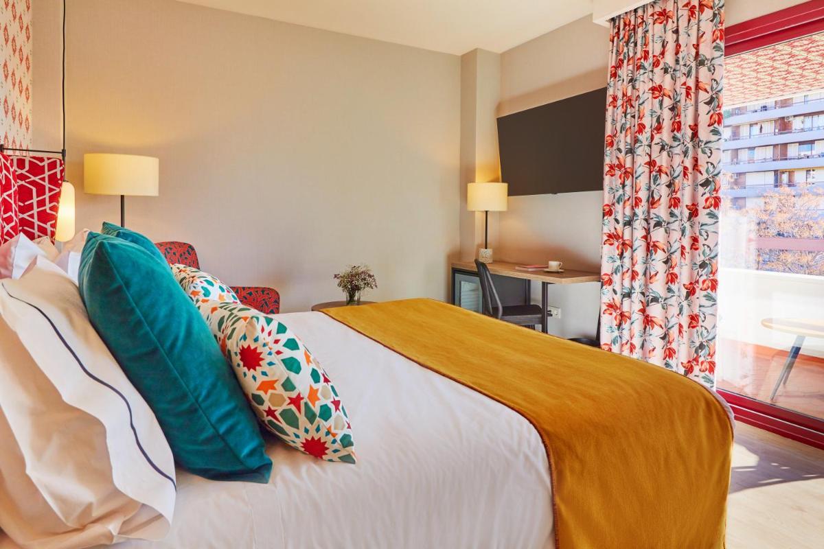 Cama o camas de una habitación en Hesperia Sevilla