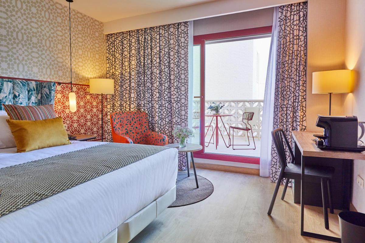 Cama o camas de una habitación en Hesperia Sevilla