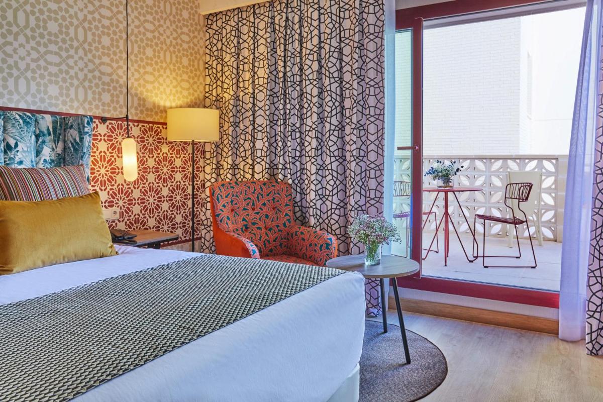 Cama o camas de una habitación en Hesperia Sevilla