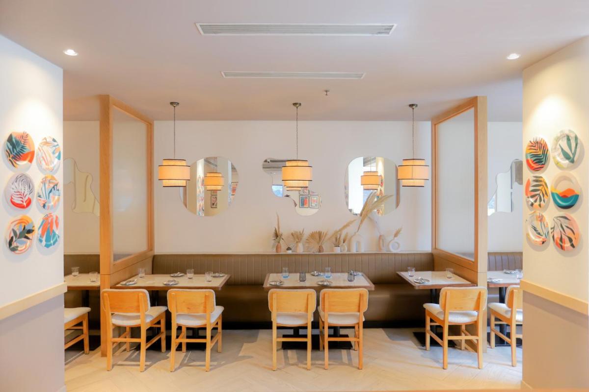 a dining room with a table and chairs at Park Inn by Radisson,South Delhi in New Delhi a dining room with a table and chairs at Park Inn by Radisson,South Delhi in New Delhi