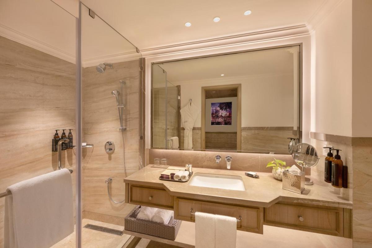 a bathroom with a sink and a shower at Aurika, Mumbai International Airport - Luxury by Lemon Tree Hotels in Mumbai a bathroom with a sink and a shower at Aurika, Mumbai International Airport - Luxury by Lemon Tree Hotels in Mumbai