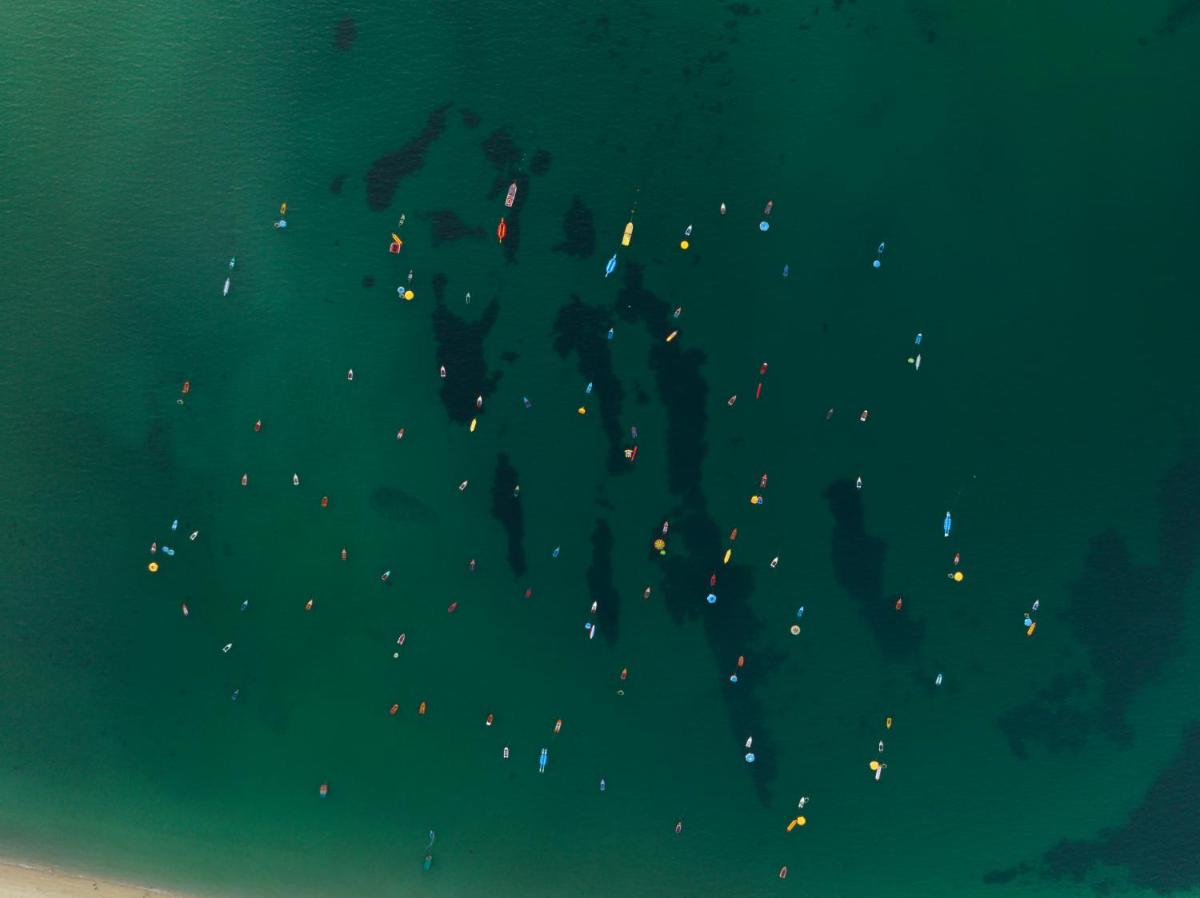 a group of people in the water at night at Hawthorn Suites by Wyndham Dwarka in Dwarka a group of people in the water at night at Hawthorn Suites by Wyndham Dwarka in Dwarka