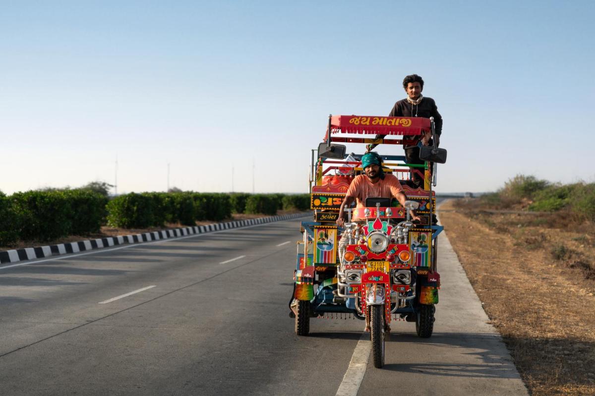 a man is riding a truck on a road at Hawthorn Suites by Wyndham Dwarka in Dwarka a man is riding a truck on a road at Hawthorn Suites by Wyndham Dwarka in Dwarka