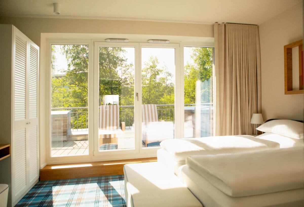 Ein Bett oder Betten in einem Zimmer der Unterkunft Aalernhüs hotel & spa