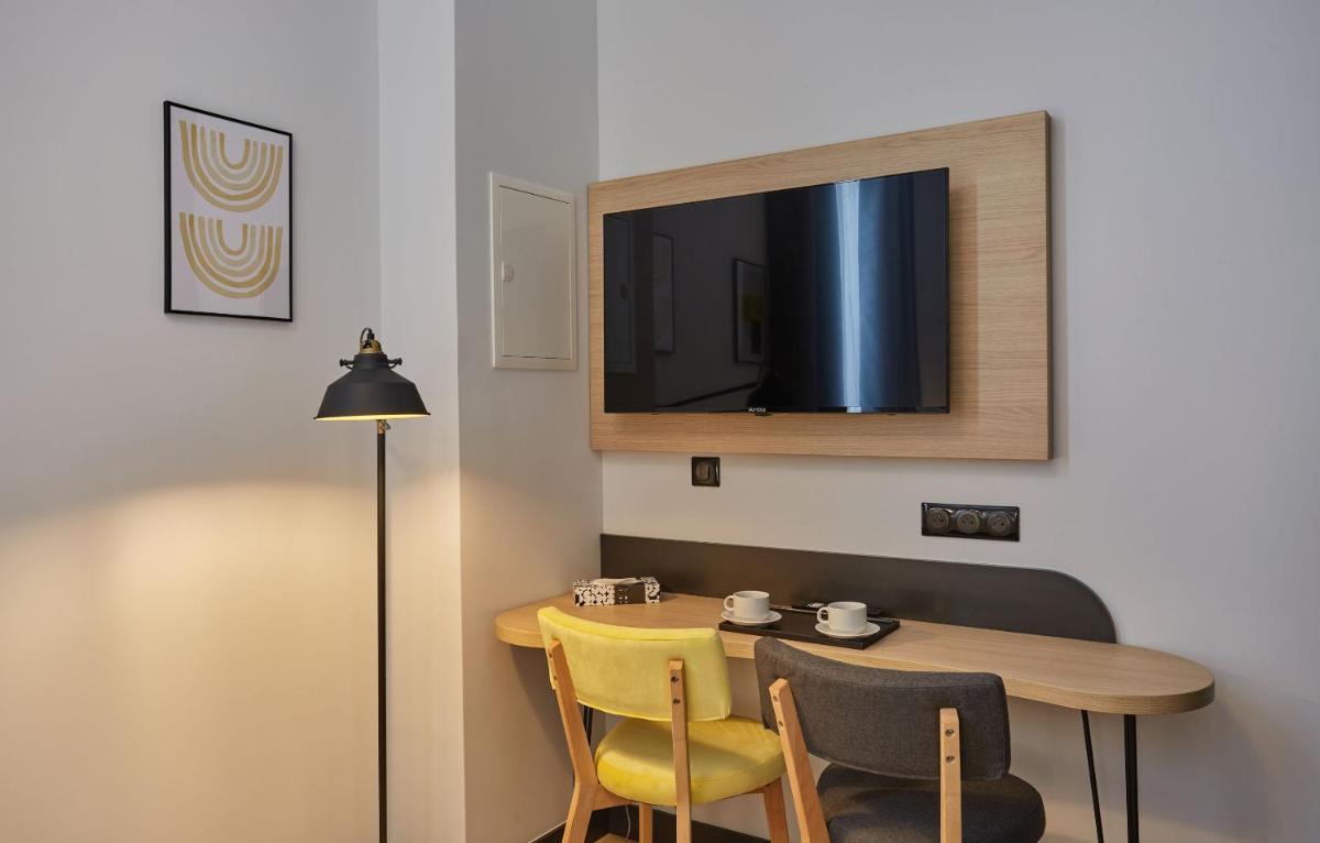 Télévision ou salle de divertissement dans l'établissement Appart'hôtel Odalys City - Nîmes Arènes - Palais des Congrès